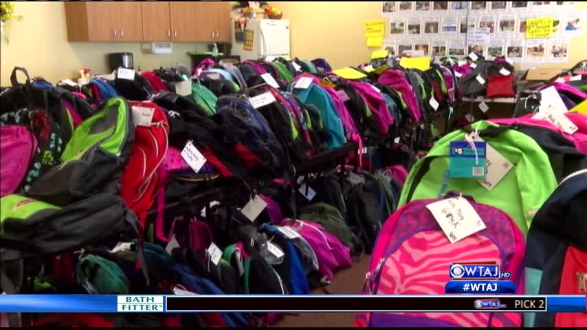 Volunteers prep backpacks for stuff the bus_19735175-159532